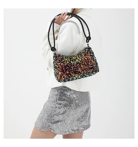 Close-up of a stylish sequin underarm bag featuring colorful glitter and silver chain detail