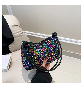 Close-up of vibrant multicolored sequins on the crescent shoulder bag with zipper detail