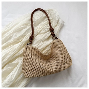 Detail of woven straw bag showing the intricate grid texture and knotted leather strap