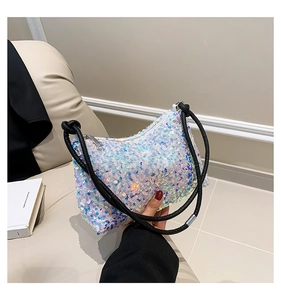 Detailed macro view of iridescent sequins on a stylish hobo bag with braided black rope straps