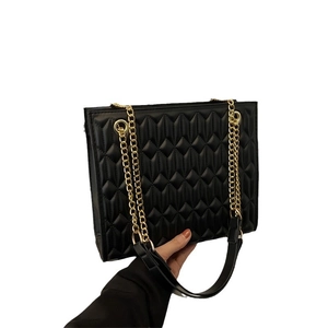 Chic black quilted chain shoulder bag with elegant gold hardware for modern women