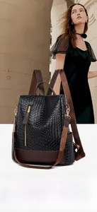 Detail of anti-theft back zipper and woven texture on a vintage black PU backpack