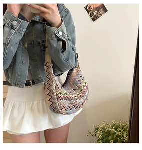 Nahaufnahme einer Vintage Ethno-Webtasche mit bunten Wellenmustern für Damen
