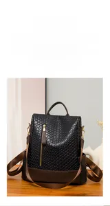 Close-up of woven pattern black PU leather backpack with secure anti-theft zipper detail