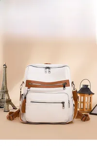 Close-up of vintage patchwork backpack with lychee texture and tassel zip detail
