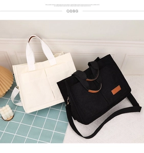 Detail view of corduroy tote bags with outer pockets and fashion leather label