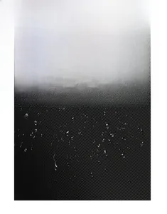 Detailed view of water-resistant black oxford fabric with droplets on nylon surface