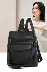 Detail of multifunction black pebbled leather backpack with adjustable shoulder straps
