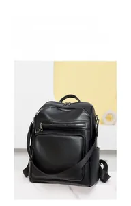 Detail view of the vintage black PU leather backpack with multiple zipper pockets