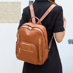 Brown faux leather fashion backpack with gold zippers and large capacity for daily travel
