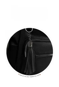 Close-up of black pebble leather texture with silver metal zipper and tassel detail