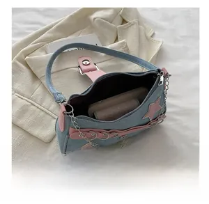 Internal view of denim star bag showing space for a smartphone and small wallet