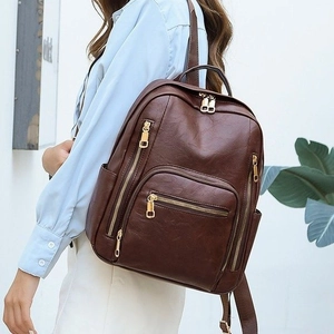 Deep brown leather fashion backpack with gold zippers and large capacity for travel