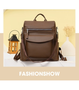 Detail of dark brown lychee textured leather backpack with wide detachable shoulder strap