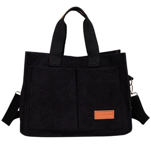 Black corduroy tote bag with dual front pockets and adjustable shoulder strap