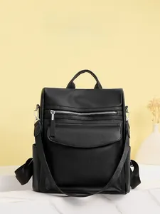 Detail view of black pebble leather backpack with multiple zipper pockets and side pockets