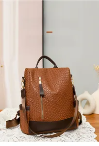 Detail of brown woven PU leather backpack with vintage texture and gold zipper accents