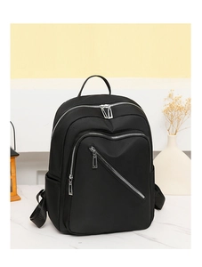 Close-up of black nylon backpack with functional silver metal zippers and side pockets