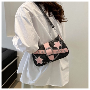 Detail view of black woven underarm bag featuring pink stars and silver chain accents