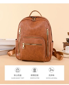 Detail of vintage brown leather backpack with gold zippers and large front storage pocket