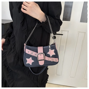 Detail of blue denim shoulder bag with pink leather stars and silver metal chain strap