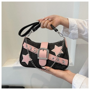 Detail of Y2K denim shoulder bag with pink stars and silver chain on model