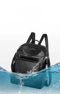 Close-up of waterproof black leather backpack texture with water droplets and scratch resistance
