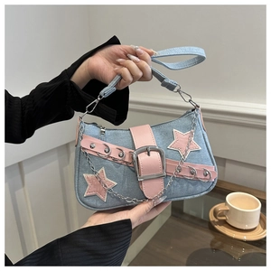 Detail of light blue denim star bag featuring pink leather stars and large metal buckles