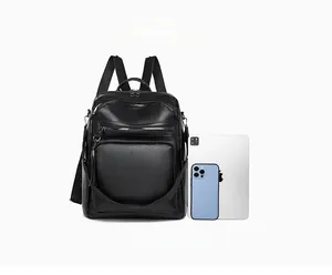 Practical internal storage of black canvas backpack shown with a tablet and smartphone