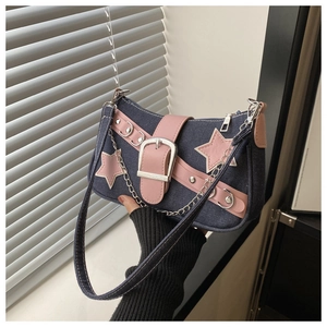 Detail of blue denim star bag with pink leather strap and decorative silver buckle