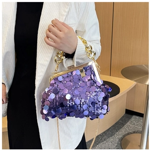 Detailed close-up of purple sequin evening bag with gold clasp and chain handle