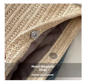 Close-up of straw tote bag showing brown fabric lining and silver magnetic buckle