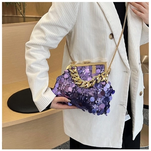 Detail of purple sequin evening bag with gold chain strap and vintage metal frame clasp