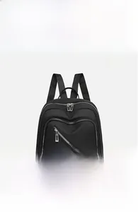 Front view of black waterproof nylon backpack with unique diagonal zipper pocket detail