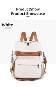 Close-up of white pebble leather backpack featuring tassel zipper and brown straps