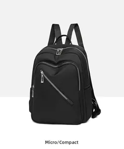 Side view of black nylon backpack showing smooth texture and silver zip details