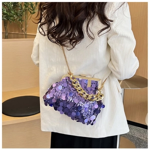 Detailed close-up of a purple sequin bag with gold chain strap and chunky handle