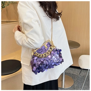 Detailed view of a purple sequined crossbody bag with gold chain strap and clip closure