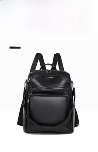 Front view of black pebbled leather backpack with large pocket and decorative tassel