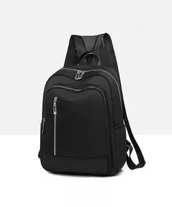 Detail view of the black waterproof nylon backpack featuring unique vertical front zippers