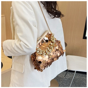 Detail of rose gold sequin clutch bag with metal frame and bold gold chain strap