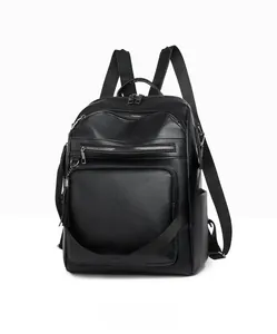 Detailed side view of black textured leather backpack with multi-layer zipper pockets