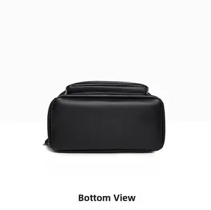 Detailed bottom view of black leather travel backpack showing textured finish and stitching