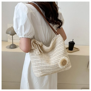 Detail of sunflower tote showing woven texture, lace bow, and leather strap contrast