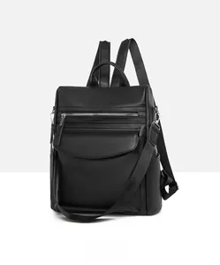 Detail of black lychee grain leather backpack with convertible straps and multi-pocket design