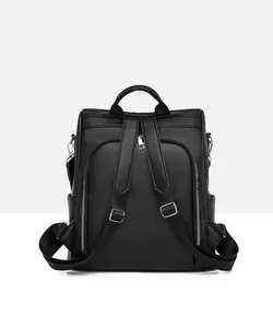 Detailed back view of black pebble grain leather backpack with adjustable straps and hardware