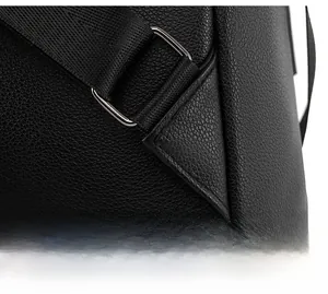 Detail of reinforced triangular stitching and silver buckle on black leather backpack