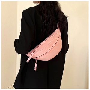 Detailed back view of pink nylon crescent waist bag worn over a black blazer