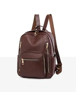 Detailed side view of dark brown PU leather backpack showing multi-zipper compartments