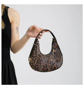 Close-up of leopard print hobo bag showing the gold zipper and shoulder strap details